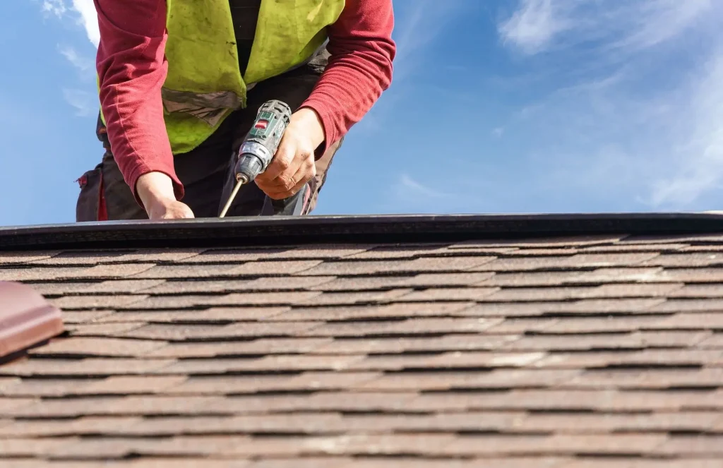 Roofing professional performing residential roof maintenance in Baldwin County, AL