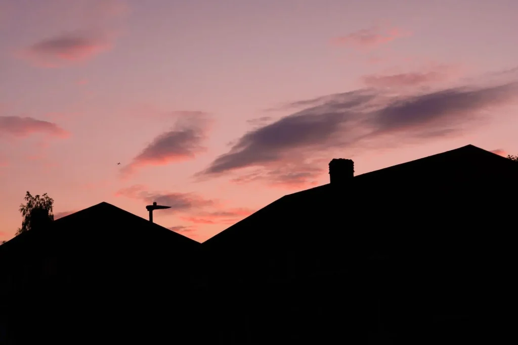 Residential home silhouette against sunset