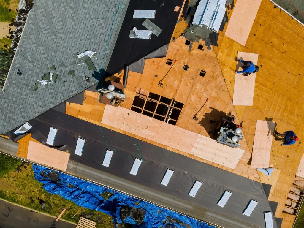 Aerial view of roofers working on residential home